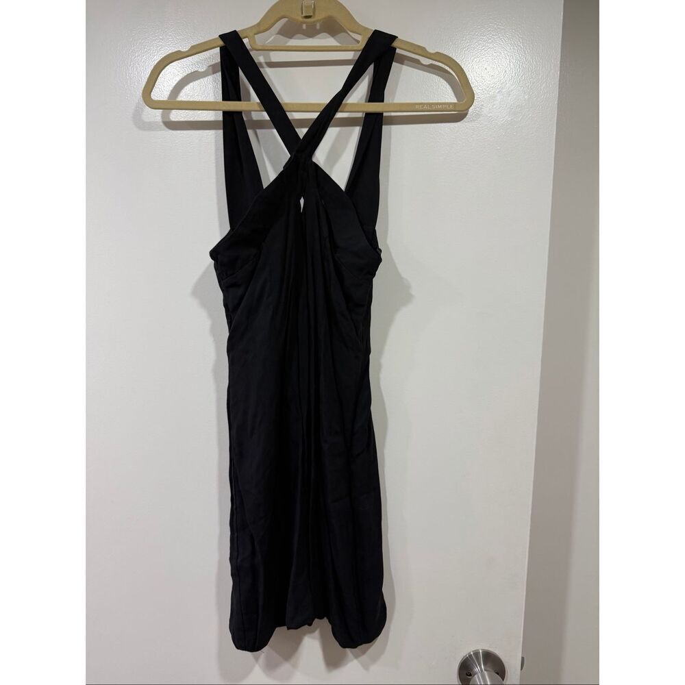Olcay Gulsen’s size XS black mini dress features a crossed design.
